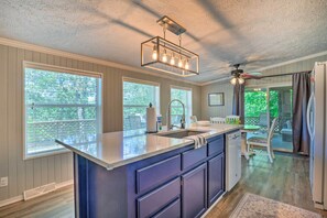 Enjoy cooking in this well-designed kitchen with a central island, sink, and ample counter space.