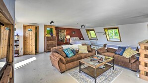 A cozy living room with a brown sofa set, a glass coffee table, and a wooden bookshelf. - Charming Studio ~ 20 Mi to Acadia Nat'l Park! (Ellsworth)