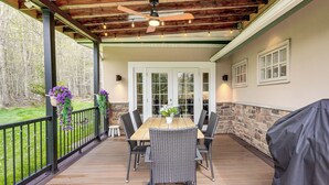 An outdoor patio with a wooden table and chairs, a ceiling fan, and a grill. - Poconos Cottage w/ Sauna ~ 10 Mi to Camelback! (Tobyhanna)