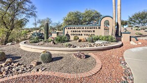 A sign for "Canoa Seca Estates II" and "Canoa Vistas II" with a landscaped garden featuring cacti and a circular brick pathway. - Tranquil Green Valley Townhome w/ Mtn Views! (Green Valley)