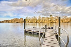Guests can access the calm water from this dock, surrounded by a dense forest.