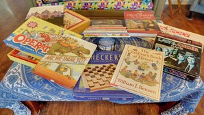 A variety of board games and books on a table. - Springfield Apt w/ Deck + Central Location! (Springfield)