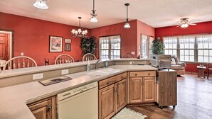 A kitchen with a large island, wooden cabinets, and pendant lighting. - Pet-friendly Abingdon Abode w/ Yard & Grill! (Abingdon)