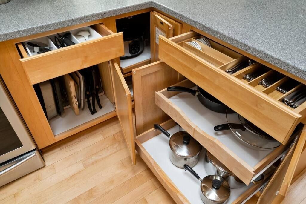 A kitchen with wooden cabinets, a countertop, and a built-in oven.