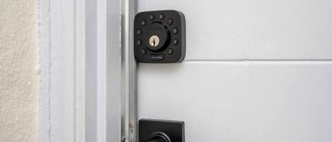 A door with a numeric keypad lock and a lever handle.