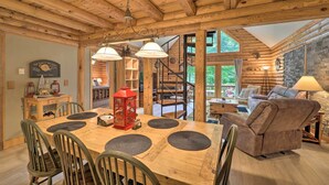 A wooden interior with a dining table, chairs, a sofa, and a staircase. - 2 Decks & Fire Pit: Scenic Beech Mountain Retreat! (Banner Elk)