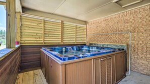 A hot tub with wooden walls and a brick wall in the background. - Private Hot Tub & Yard: Secluded Broken Bow Home! (Broken Bow)