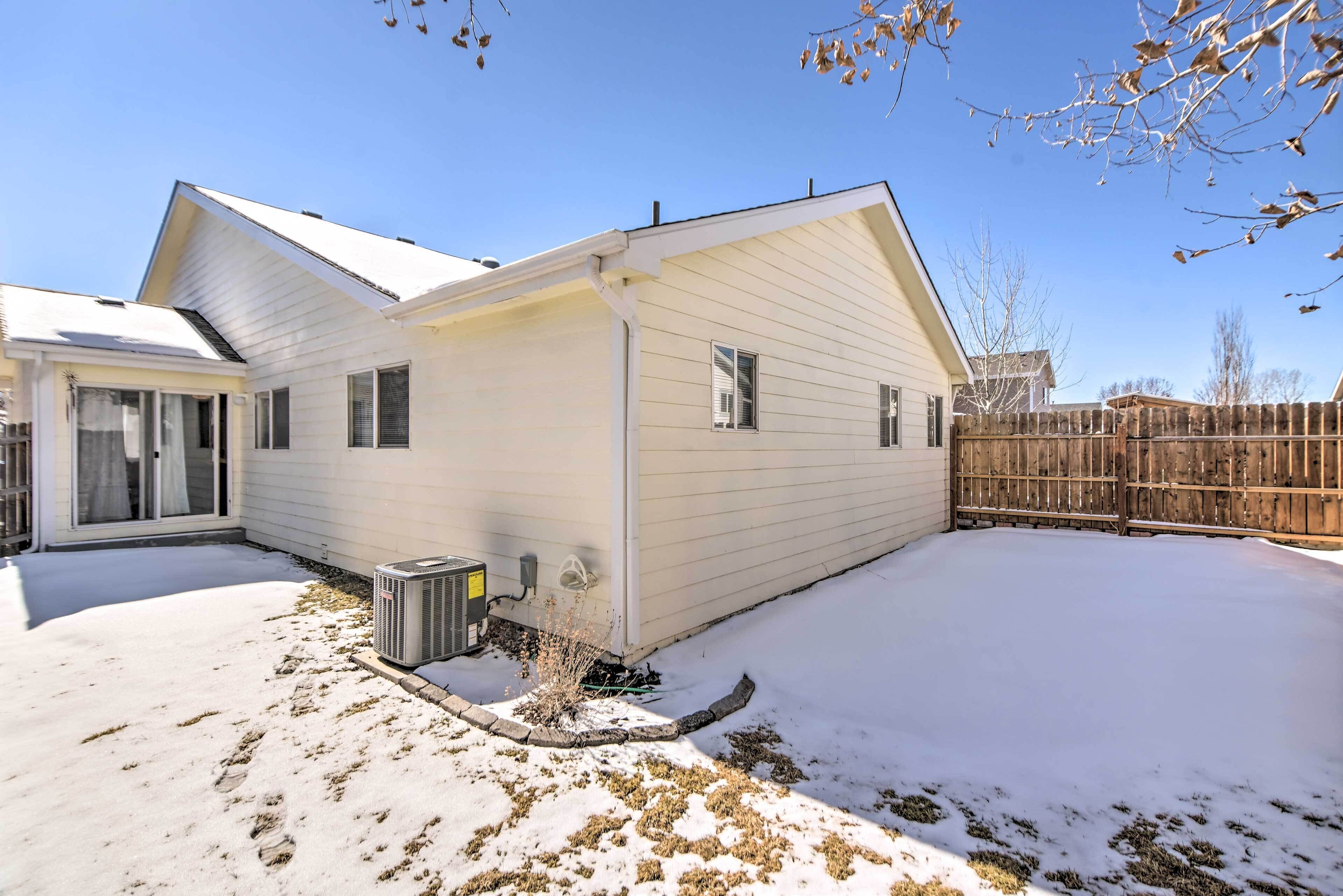 A single-story house with a covered patio and a fenced backyard.