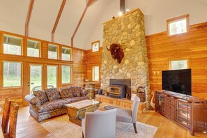 Fireplace, books - Secluded Bigfork Cabin w/ Huge Yard + Grill! (Bigfork)