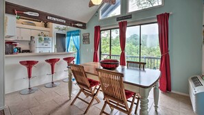 A dining area with a wooden table and chairs, a ceiling fan, and a view of the outdoors. - < 1 Mi to Lake! Osage Beach Home w/ Furnished Deck (Osage Beach)