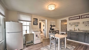 A kitchen with a refrigerator, stove, sink, and a dining area with a table and chairs. - Romantic Country Apt by Lake Erie & Wineries! (Westfield)
