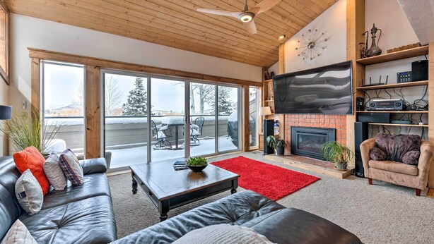 A spacious living room with a fireplace, leather sofas, a coffee table, and a TV. - 2 Mi to Park City Mtn: Townhome w/ Balcony (Park City)