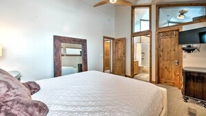 A bedroom with a large bed, wooden doors, a ceiling fan, and a television. - 2 Mi to Park City Mtn: Townhome w/ Balcony (Park City)