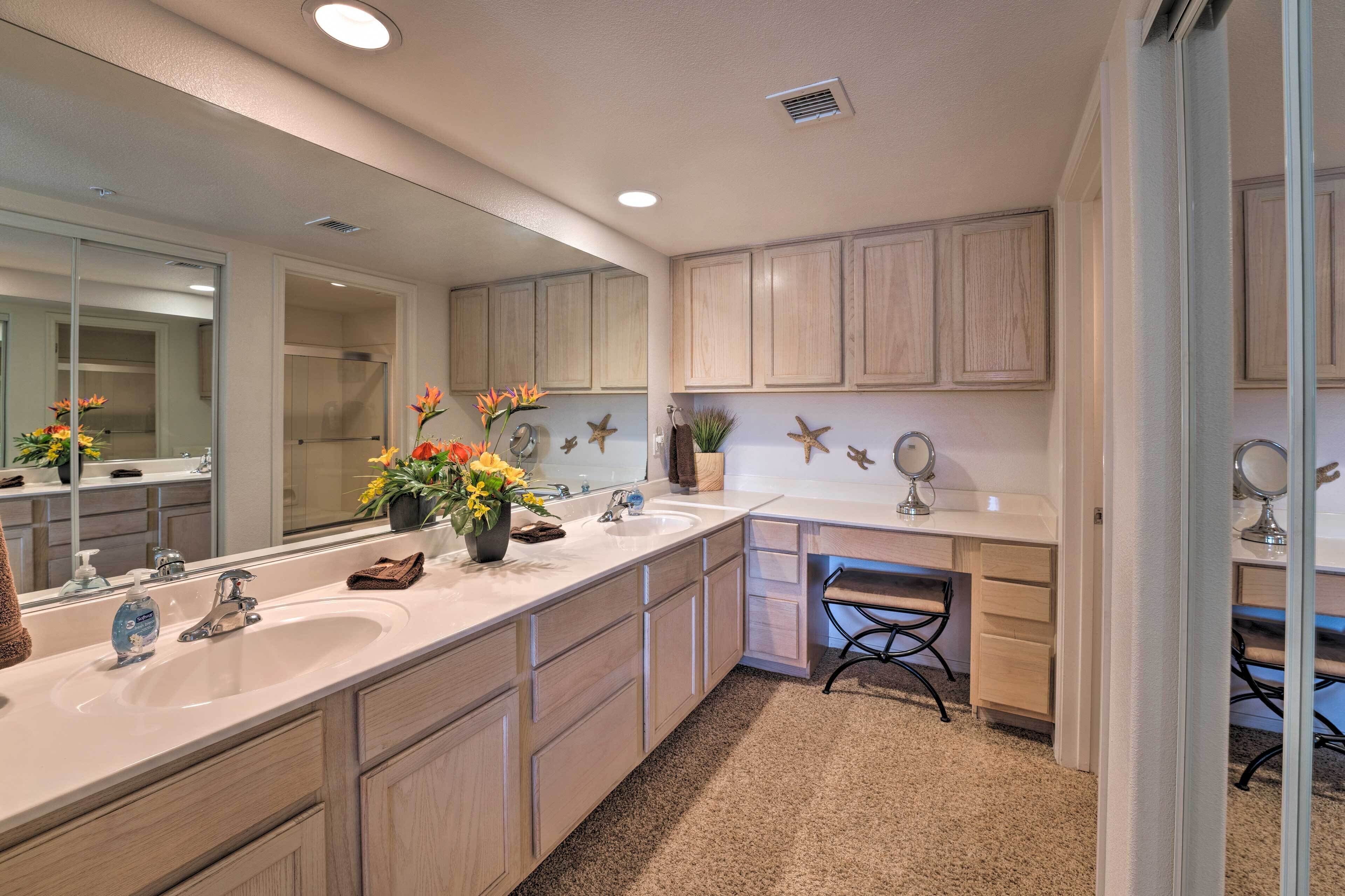 A modern bathroom with a large vanity, double sinks, and a mirror.