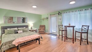 A bedroom with a bed, bedside tables, a chair, a small table, and a window with curtains. - Soothing Studio w/ Lush Views: 2 Mi to Beach! (Smith River)