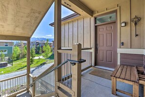 A wooden staircase with a metal handrail leading to a porch area. - Stunning Fraser Condo < 8 Mi to Winter Park! (Winter Park)
