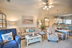 A spacious living room with a ceiling fan, a dining area with a table and chairs, and a kitchen in the background. - Little River Condo w/ Pool < 6 Mi to Beach! (Little River)