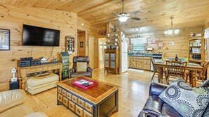 A wooden cabin interior with a living room, dining area, and kitchen. - 11 Mi to Dtwn: Franklin Cabin w/ Porch! (Franklin)