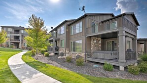 A modern two-story residential building with a stone facade, large windows, and a covered outdoor area. - Modern Huntsville Resort Retreat w/ Deck & Hot Tub (Huntsville)