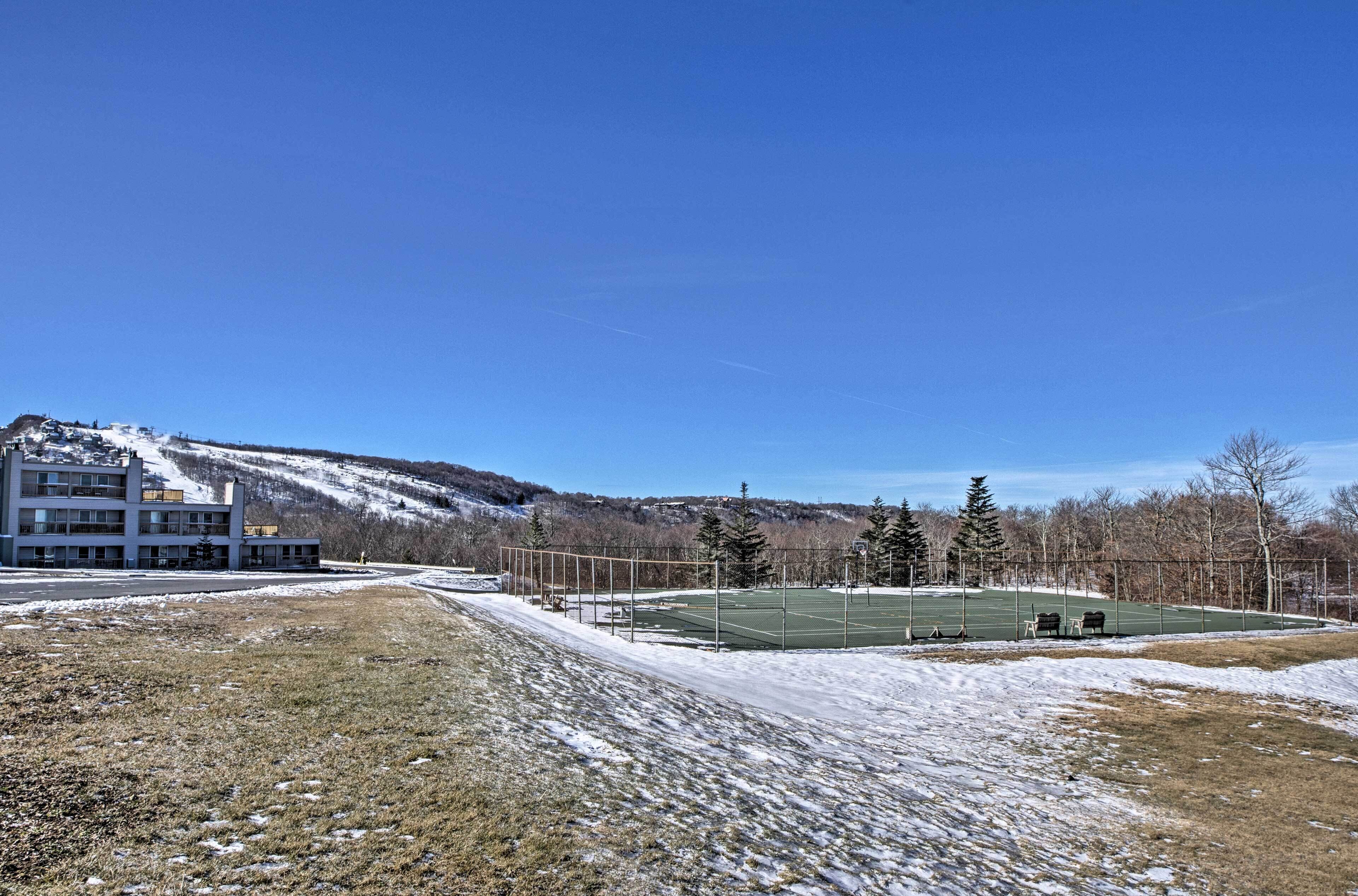A sports field with a building in the background.