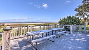 A wooden deck with picnic tables overlooking a beach. - Beach + Pool Access: Colorful Hilton Head Condo! (Hilton Head Island)