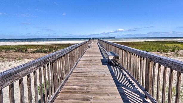 A wooden boardwalk leading to a beach with a clear sky. - Beach + Pool Access: Colorful Hilton Head Condo! (Hilton Head Island)