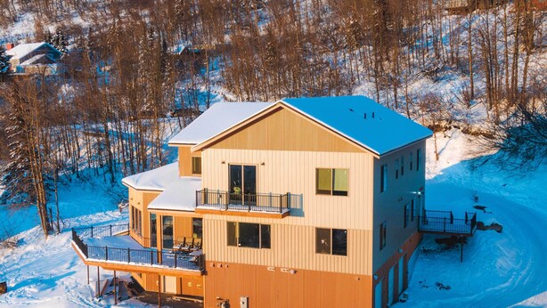 A multi-story wooden building with a balcony, surrounded by snow-covered trees. - Anchorage Studio Escape ~ 14 Miles From Downtown! (Anchorage)