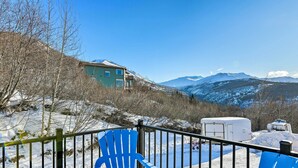 A mountain cabin with a balcony, a blue chair, and a snow-covered landscape. - Anchorage Studio Escape ~ 14 Miles From Downtown! (Anchorage)
