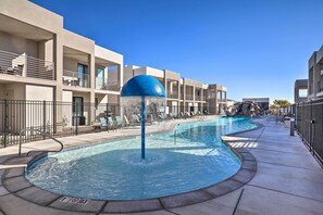 A swimming pool with a water feature, surrounded by a poolside area with lounge chairs and a clear blue sky. - Villa w/ Hot Tubs ~ 5 Miles to Historic St. George (St. George)