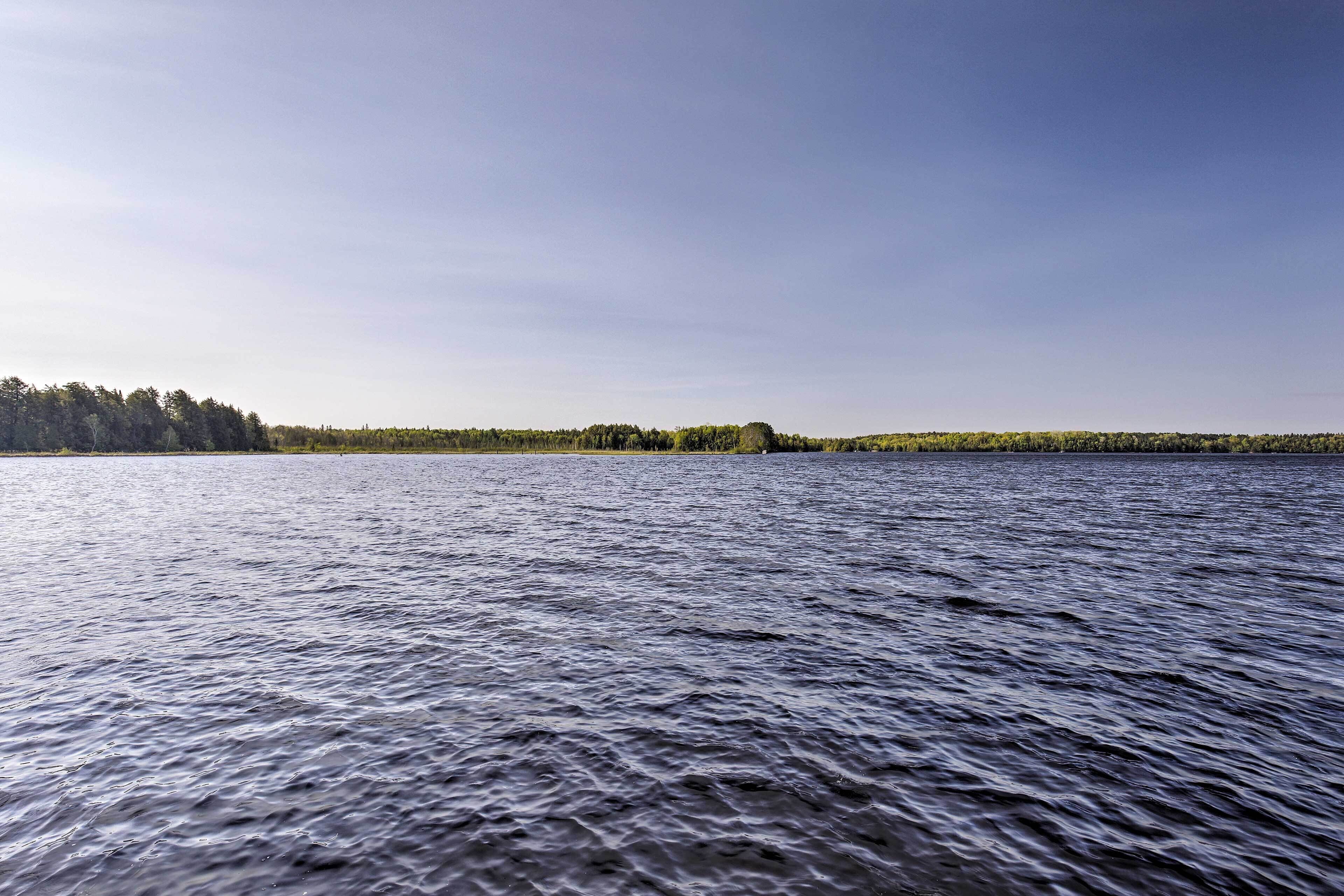 A calm lake with a forested shoreline.
