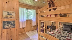 A wooden cabin room with bunk beds, a ceiling fan, and a moose plush toy. - Cozy Florence Cabin, Proximity to Keyes Peak! (Florence)