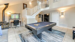 A pool table in a room with a staircase, a desk, and a chair. - Expansive Flagstaff Family Retreat w/ Media Room! (Flagstaff)