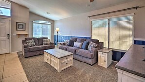 A living room with two sofas, a coffee table, a side table, and a ceiling fan. - Outdoor Kitchen, Heated Pool: Gilbert Retreat! (Gilbert)