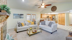 A spacious living room with a fireplace, two sofas, a coffee table, and a ceiling fan. - Valrico Vacation Rental 15 Mi to Tampa (Valrico)