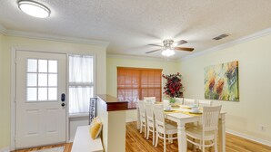 A dining area with a white table and chairs, a ceiling fan, and a painting on the wall. - Valrico Vacation Rental 15 Mi to Tampa (Valrico)