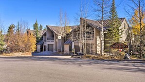 A large, multi-story building with a prominent chimney, surrounded by trees and a clear sky. - Walk to Lifts: 'chimney Ridge' Townhome w/ Hot Tub (Breckenridge)