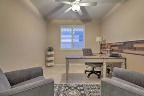 A small office with a desk, two grey chairs, a ceiling fan, a window with blinds, a lamp, and a patterned rug. - Queen Creek Oasis w/ Pool + Resort Amenities! (Queen Creek)