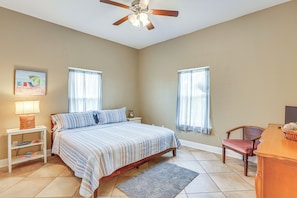A bedroom with a bed, nightstands, a chair, a desk, and a ceiling fan. - Family-friendly Waterfront Oasis: 7 Miles to Beach (Crawfordville)