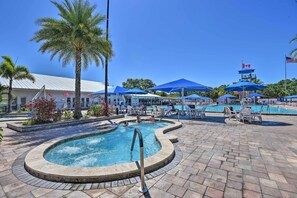 A pool area with a hot tub, lounge chairs, and umbrellas. - Sarasota Home w/ Full Resort Amenity Access! (Sarasota)