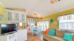 A compact living space with a television, sofa, and dining area. - Sarasota Home w/ Full Resort Amenity Access! (Sarasota)