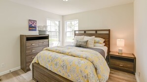 A bedroom with a bed, nightstands, a dresser, and a window. - Chic Columbia Home < 2 Mi to Historic Square! (Columbia)