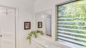 A bathroom with a white vanity, a large mirror, and a window with blinds. - Central South Pasadena Apt, 3 Mi to Rose Bowl (South Pasadena)