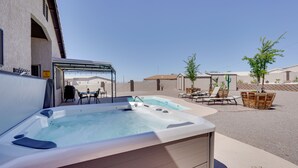 A hot tub in a covered outdoor area with lounge chairs and a patio table. - Havasu Vacation Rental w/ Private Pool & Hot Tub! (Lake Havasu City)
