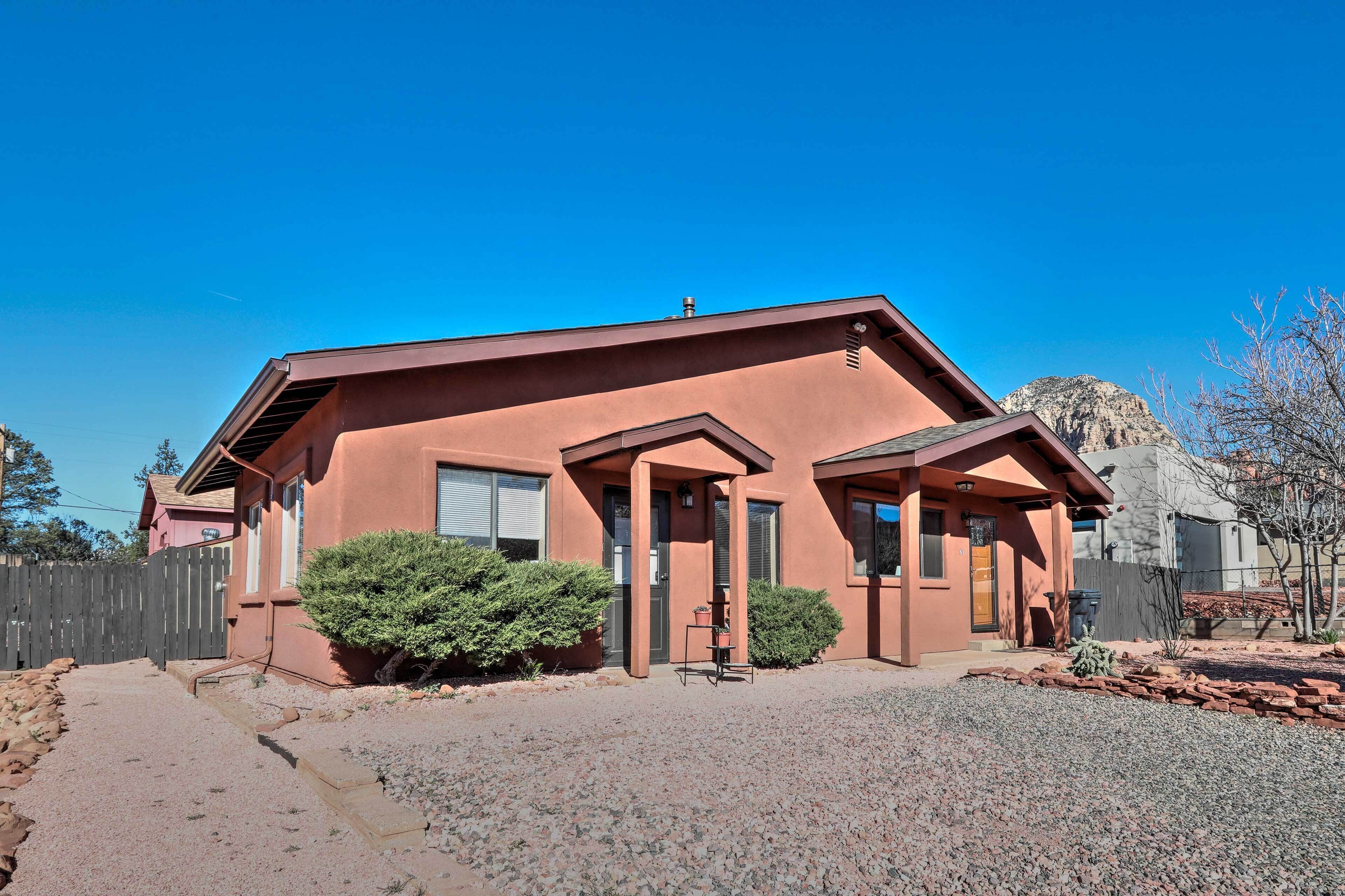 A single-story building with a flat roof, a front porch, and a gravel driveway.