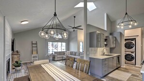 A spacious living area with a dining table, chairs, a sofa, and a ceiling fan. - Modern Flagstaff Retreat ~ 4 Mi to Downtown! (Flagstaff)