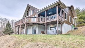 A large, two-story wooden house with a covered porch and a garage.