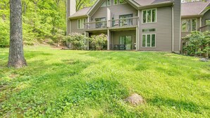 A two-story house with a large front yard, a balcony on the second floor, and a tree in the foreground. - Second-floor Condo w/ Community Pool Access! (Nellysford)