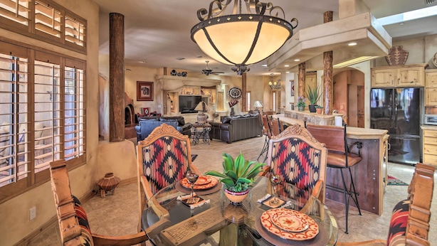 A spacious living area with a dining table, chairs, and a chandelier. - Patio, Grill & Yard: Pet-friendly Lake Havasu Gem (Lake Havasu City)