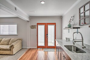 A kitchen with a double door, a sink, and a window with blinds. - Convenient Burien Getaway: 12 Mi to Dtwn Sea! (Burien)