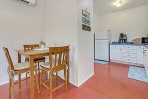 A compact kitchen with white cabinets, a refrigerator, and a coffee maker. - Private Desert Garden: Cozy Tucson Casita (Tucson)